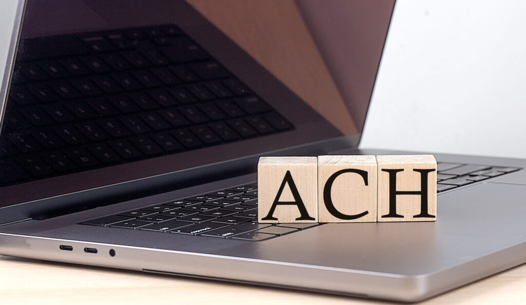 ACH letters on wood blocks on computer