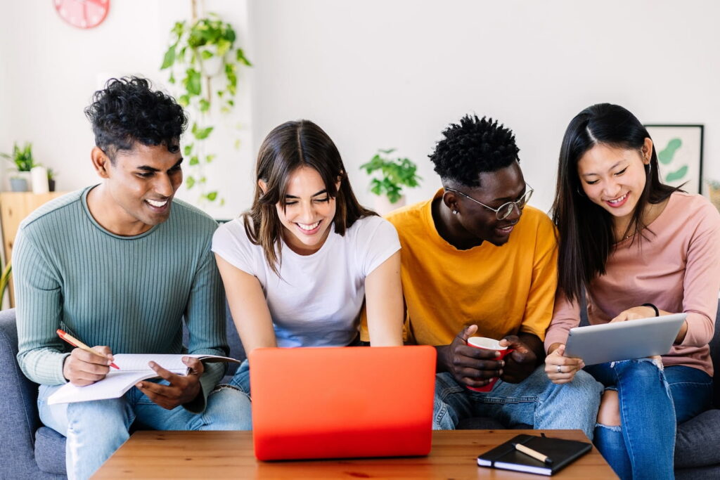 Group of men and women looking at tablets and computers