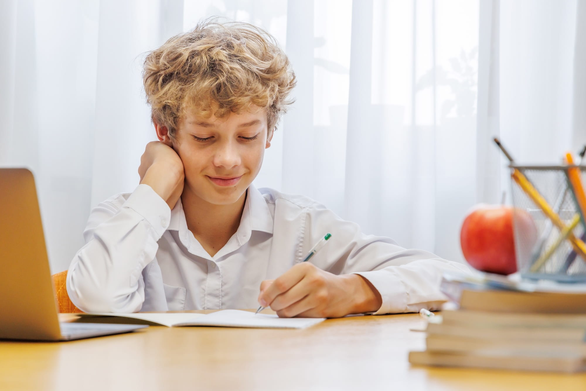 Young boy working on homework at kitchen table