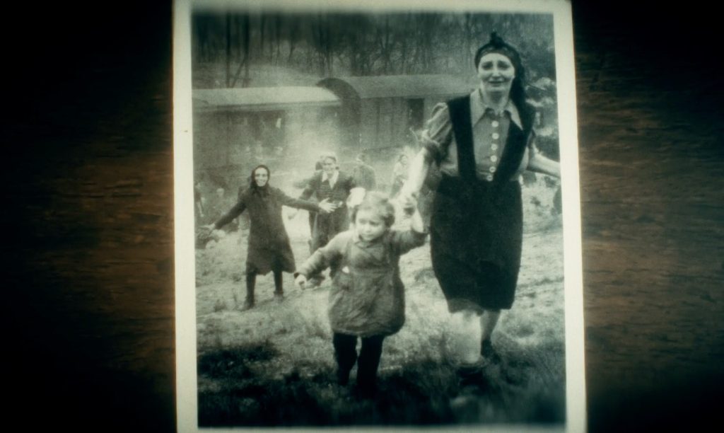 Photograph of woman holding hands with a child, both running with a train behind them